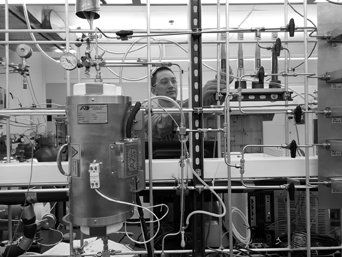 photo: chemical and biomolecular engineering assistant professor Dante A. Simonetti sets up a packed bed reactor