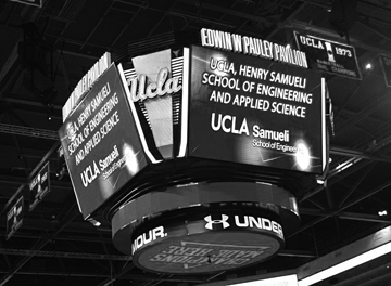 Pauley Pavilion center-court scoreboard showing UCLA Engineering signage at commencement ceremony