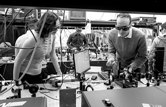 Professor Mona Jarrahi and her group work on a terahertz spectroscopy setup.