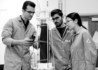 Graduate student researchers (L to R) Abolfazl Sadeghpour, Navid Ebrahimi, and Hangjie Ji experiment with
their novel water vapor capture system in professor Sungtaek Ju’s Multiscale Thermosciences Laboratory.