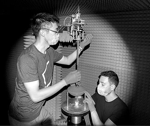 Students Junbo Wang and Anastasios Papathanasopoulos with antenna inside anechoic chamber